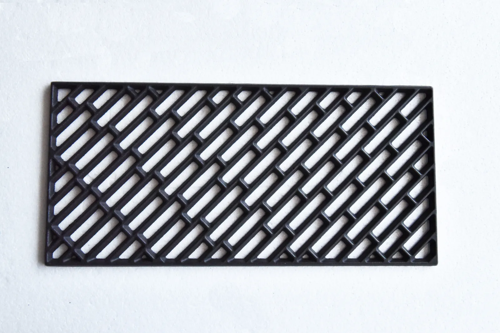 Cast iron grill grate sample photographed as an OEM BBQ component